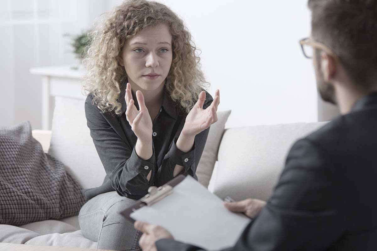 a woman asks her therapist what is trauma therapy