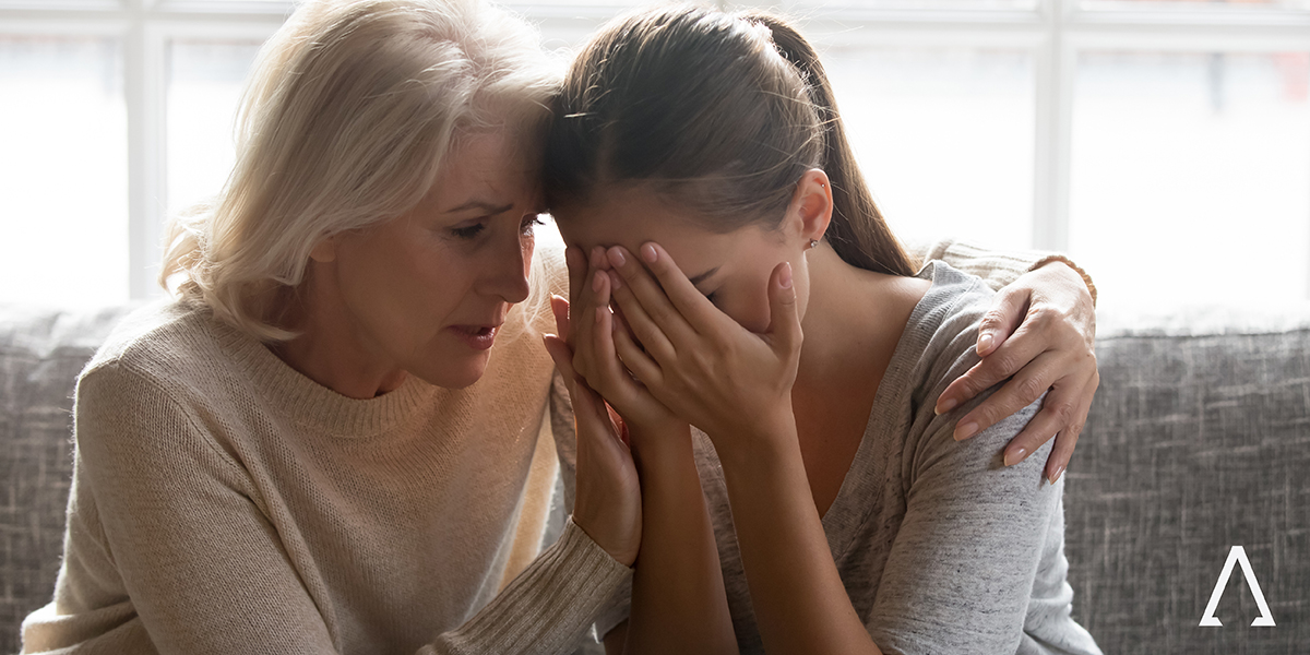 woman consoling younger woman
