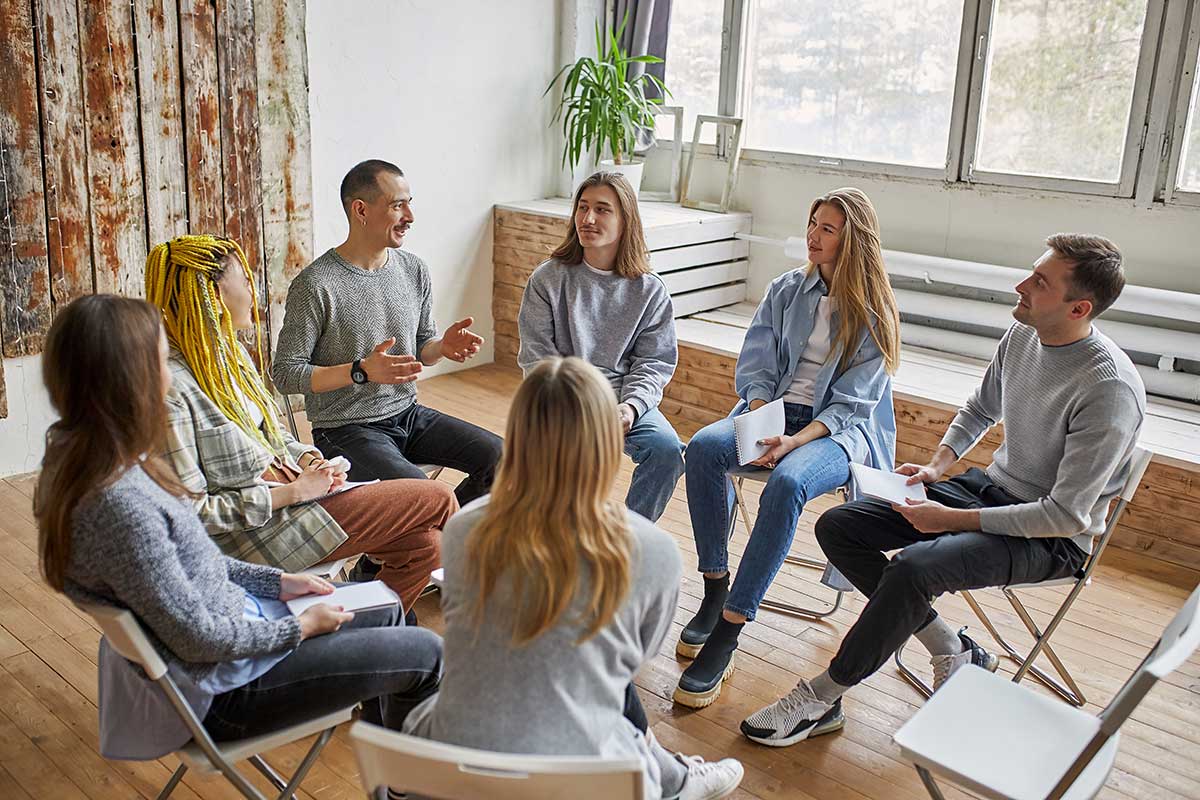 people learning the benefits of a group therapy program