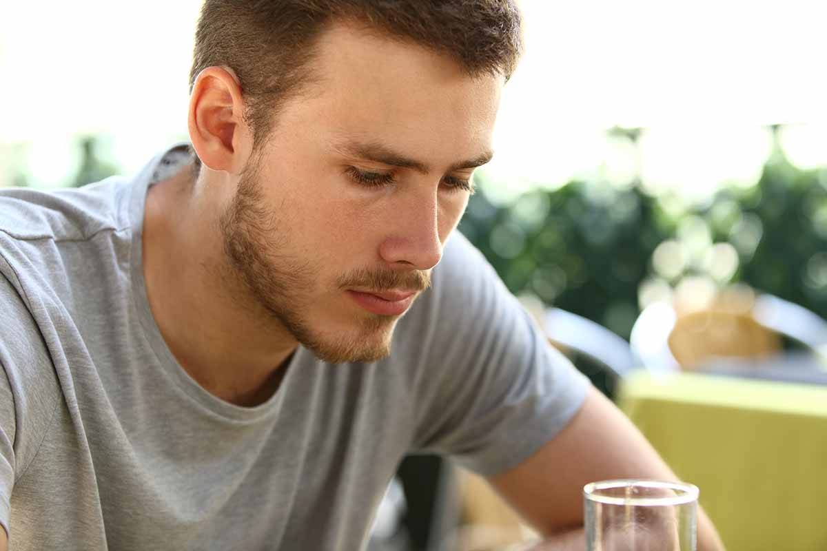 a man considers the need for men's alcohol addiction treatment